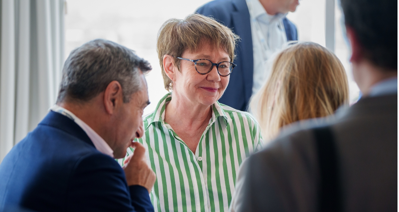 EBRD President, Odile Renaud-Basso talking to alumni at a reception.